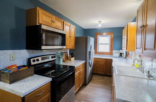Woodward House | Blue house on 5th! Arcade room, fire pit, privacy fenced yard, and more!