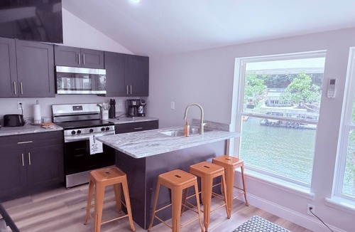 Osage Beach Cabin | Cozy 740 sq ft A-frame cabin at North Shore Resort with lake views, 1 bedroom + loft (sleeps 6), full kitchen, island seating, and a private deck—perfect for relaxing getaways at Lake of the Ozarks.