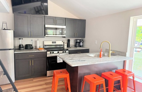 Osage Beach Cabin | Cozy 740 sq ft A-frame cabin at North Shore Resort with lake views, 1 bedroom + loft (sleeps 6), full kitchen, island seating, and a private deck—perfect for relaxing getaways at Lake of the Ozarks.