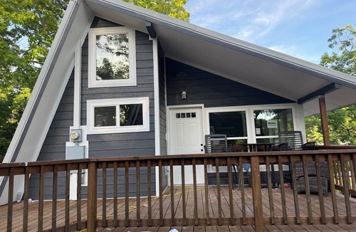 Osage Beach Cabin | Cozy 740 sq ft A-frame cabin at North Shore Resort with lake views, 1 bedroom + loft (sleeps 6), full kitchen, island seating, and a private deck—perfect for relaxing getaways at Lake of the Ozarks.