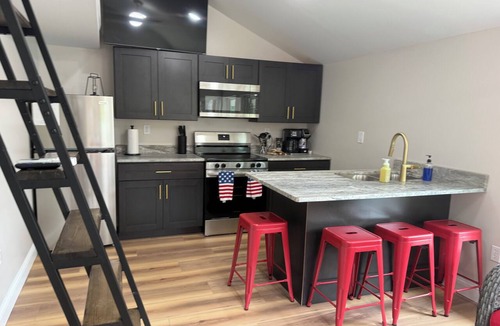 Osage Beach Cabin | Cozy 800 sq ft A-frame cabin at North Shore Resort with lake views, 1 bedroom + loft (sleeps 6), full kitchen, island seating, and a private deck—perfect for relaxing getaways at Lake of the Ozarks.