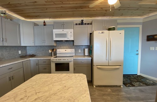 Little Sturgeon House | Prime sunsets, great kayaking, huge yard, volleyball court, and free firewood