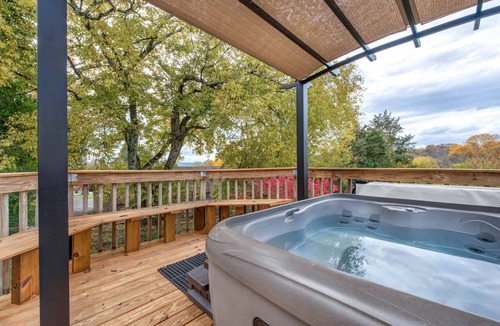 Sevierville Cabin | River-View Home w/Multi-Level Deck, Yard, Hot Tub, & Free Attraction Tickets