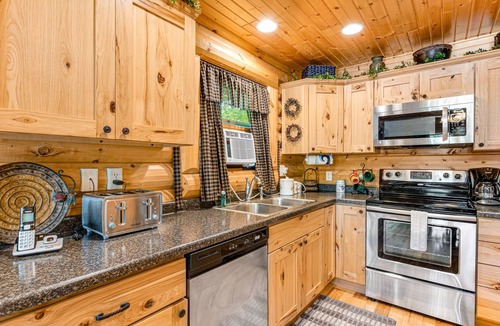Lyndon Station Cabin | Riverfront cabin with a dock, kayaks and a canoe - firepit and water views