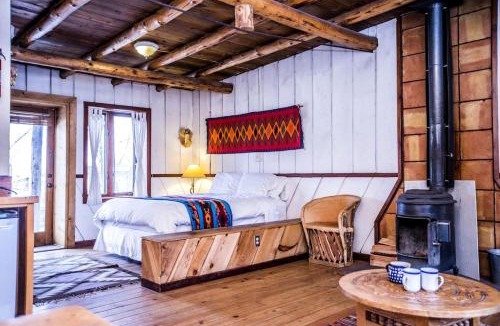 San Cristobal House | Rustic Log Cabin on Eco-Friendly Farm near Taos, New Mexico