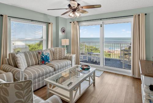 Direct oceanfront 2/2 corner condo with large balcony, heated pool, and garage parking