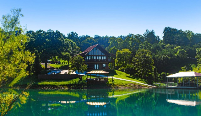 Lakefront cabin with views, boat ramp, dock, hot tub, & free attraction tickets